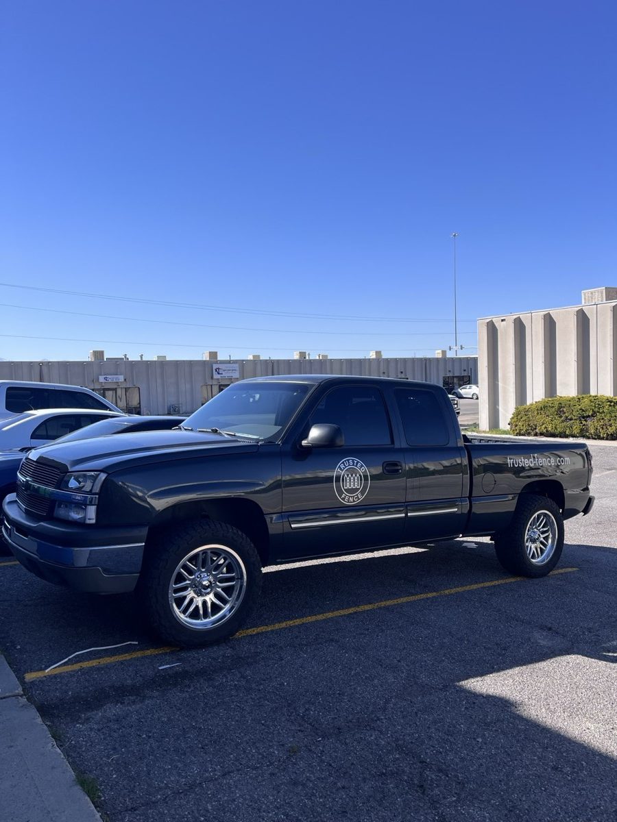 Trusted Fence company truck with the seal logo on the door