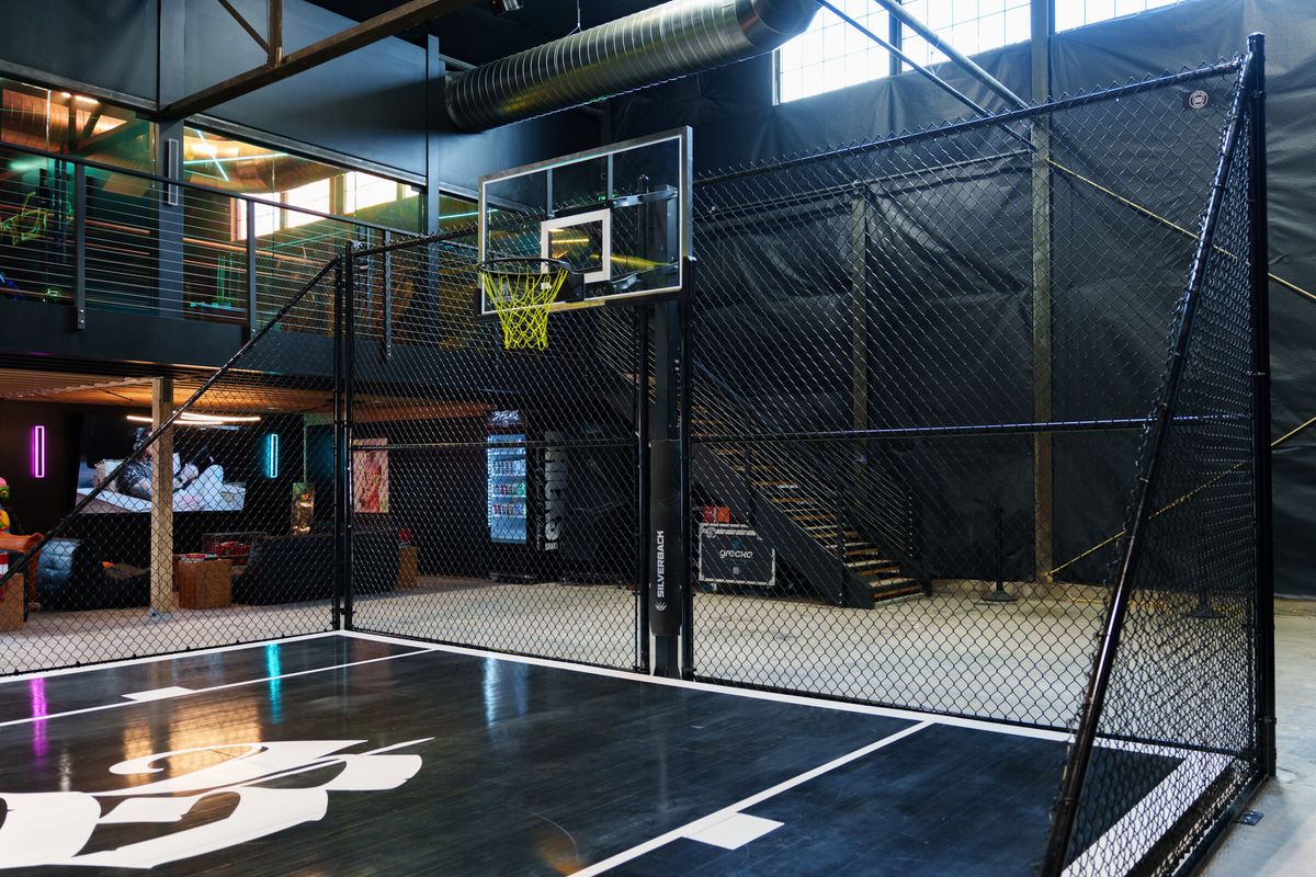 Black chain link cage around an indoor basketball court in a facility in Salt Lake City, UT