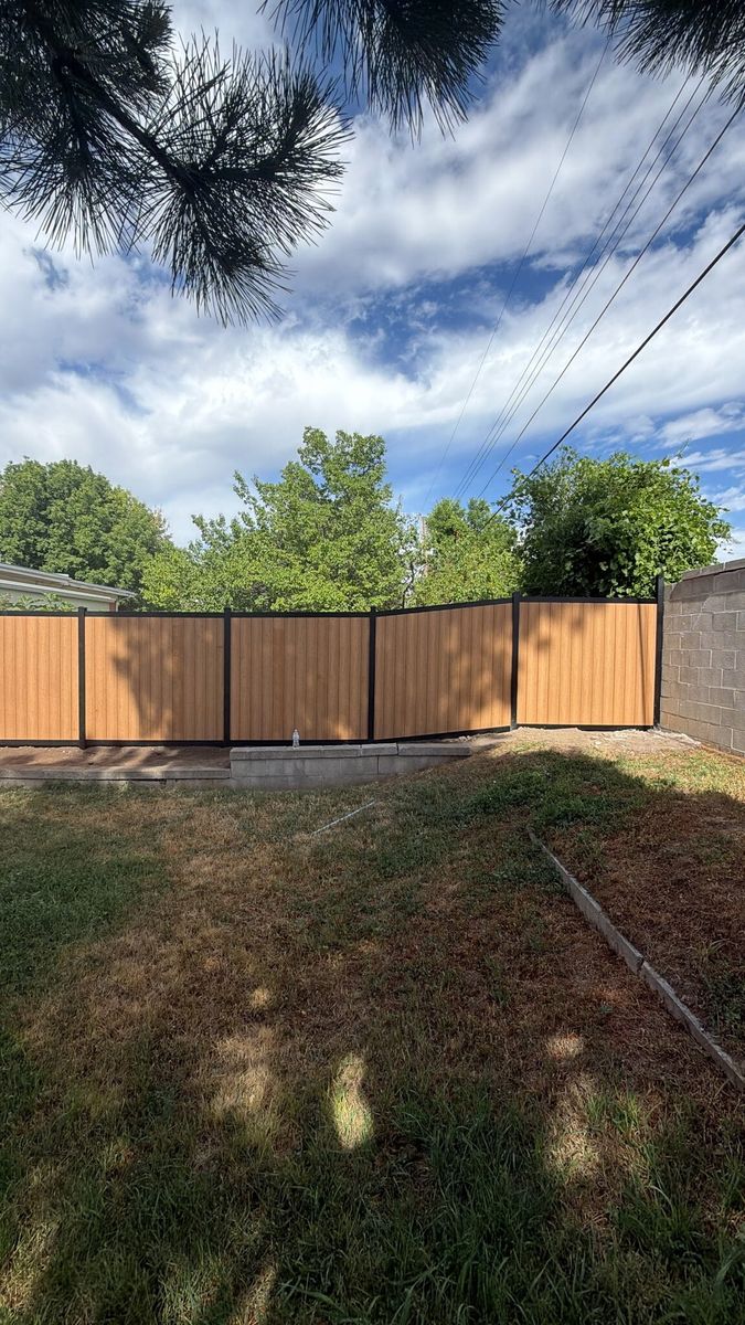 Woodgrain composite privacy fence enclosing a backyard in Draper, UT